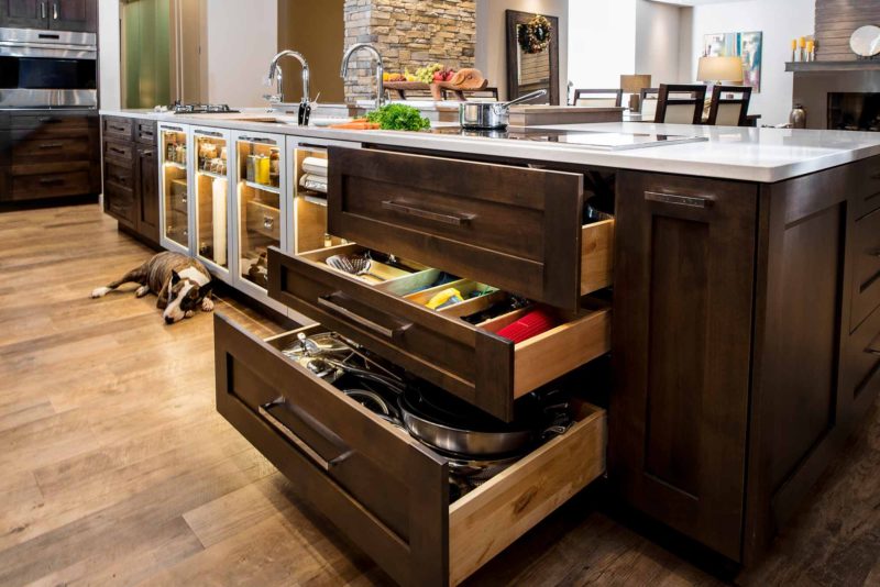 Heart of the Treehouse 11 modern kitchen with pullout storage below the induction cooktop on the island