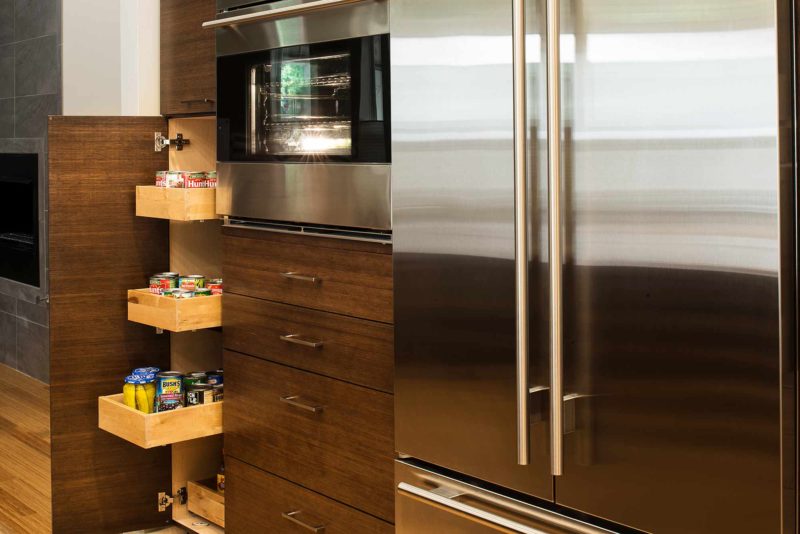 Walnut Galley 5 contemporary kitchen with tall pantry pullout storage, refrigerator and ovens