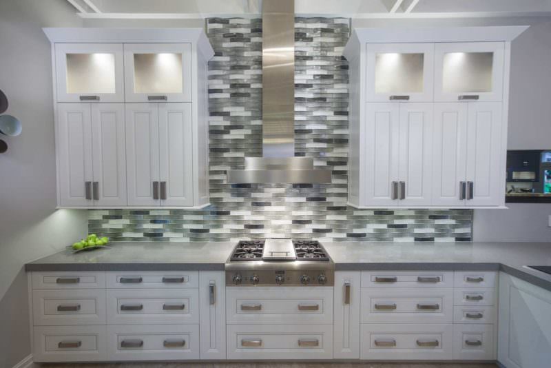 Leaves You Jonesin 2 contemporary kitchen with Thermador gas range top, vent hood above and tile backsplash